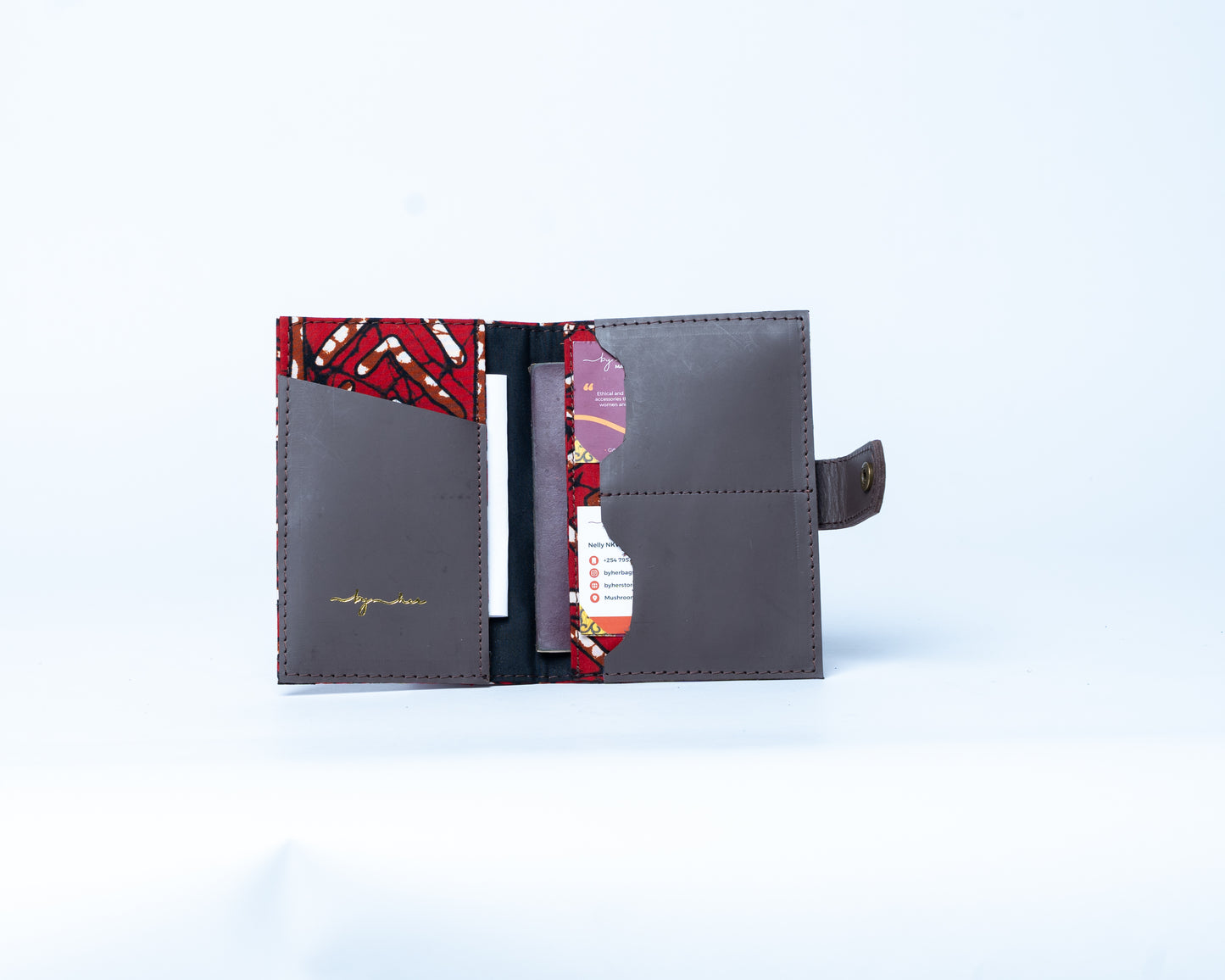 Open wallet with red and black patterned interior on a white background