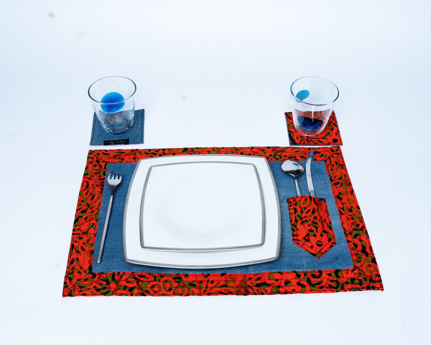Placemat with cutlery and glasses on a white background
