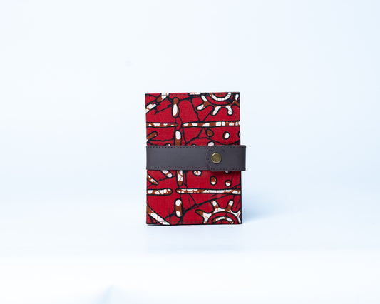 Red patterned wallet with a gray strap on a white background
