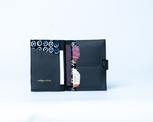 Black travel wallet with patterned card slots on a white background