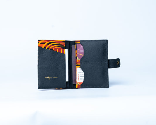 Black leather wallet with colorful interior on a light blue background