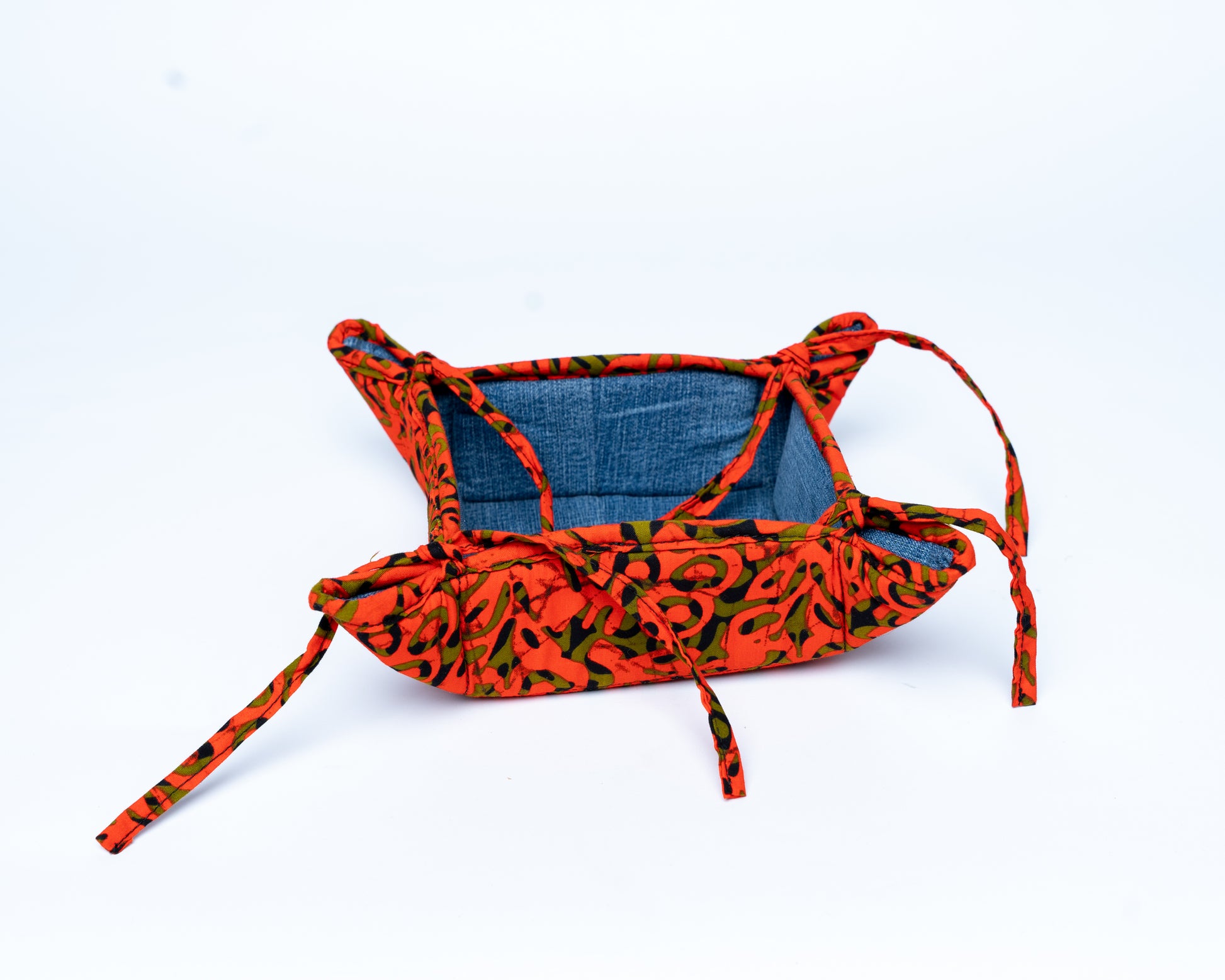 Dog harness with red and green pattern on a white background