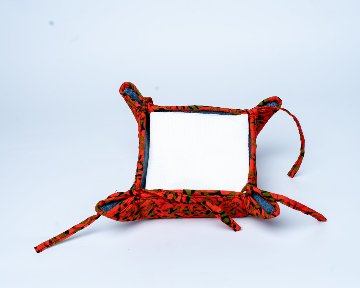 Red and black patterned dog collar on a light blue background