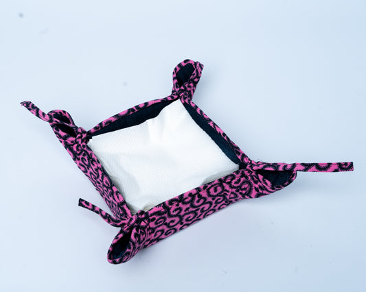 Pink leopard print headband on a white background