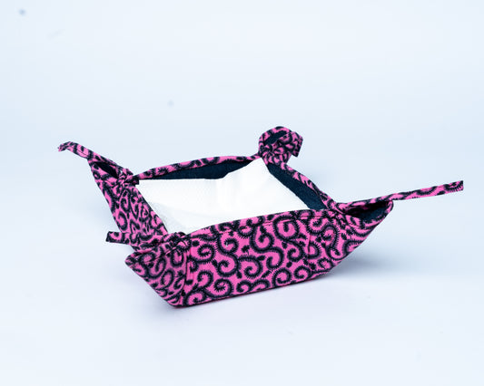 Pink and black leopard print hammock on a light blue background