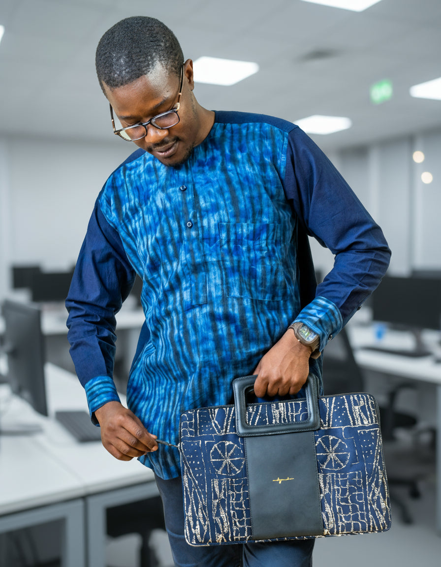Man holding a blue and white patterned bag against a white background